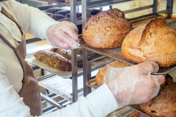 cheerful-baker-delivering-bread-to-client-in-store-2024-10-31-01-38-06-utc (1)